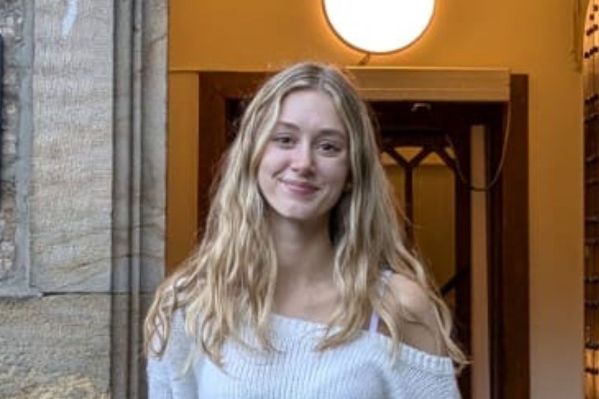 Emma Corbin smiles at the camera outside a university building