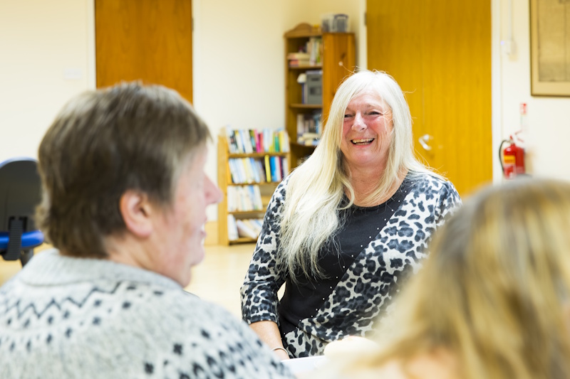 A woman laughs with friends